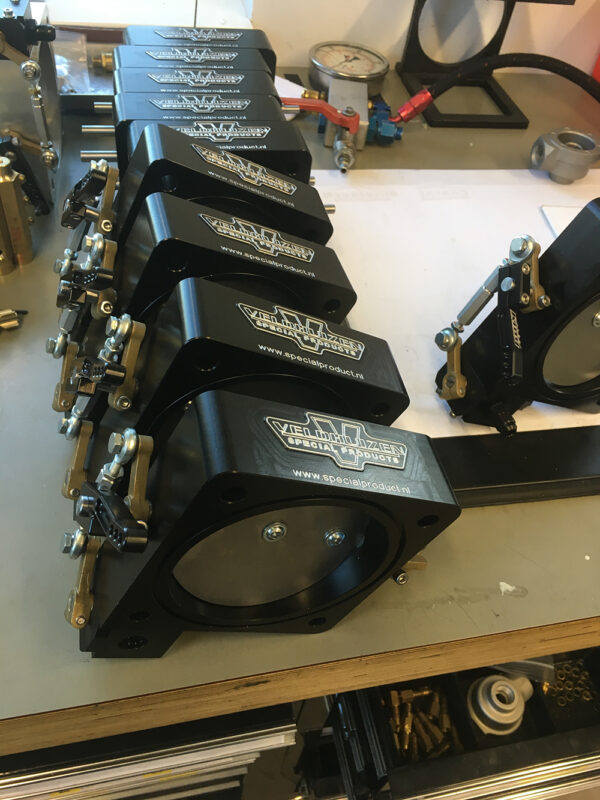 Throttle body with barrel valve idle stop and arm